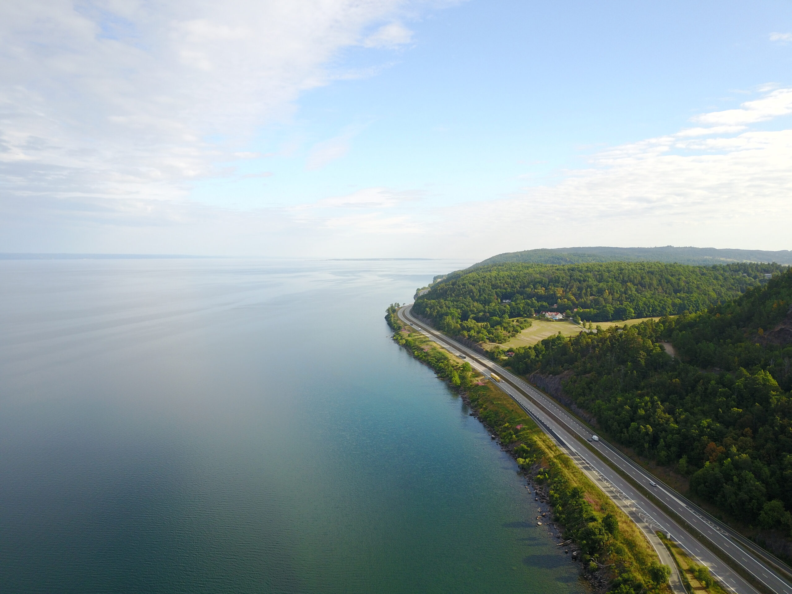 Drone,Shot,Of,The,Highway,Around,Vättern,Sweden,Bending,Away